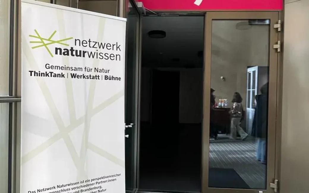 Der Eingang zum Saal “Bühne 3” des Theaters an der Parkaue wird gezeigt. Am Rand steht ein Text-Banner des Projektes Netzwerk Naturwissen.